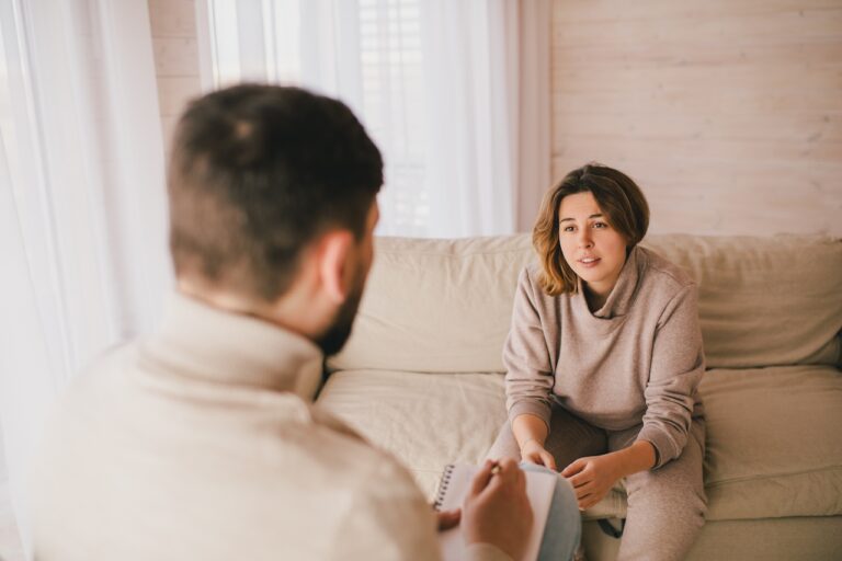 Young woman patient having consultation with life coach in his office.
