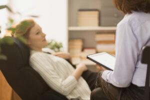 therapist talking with a patient on a couch